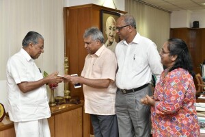 Pastor Abraham George with the Chief Minister of Kerala Pinarayi Vijayan donating to the CM's flood relief fund